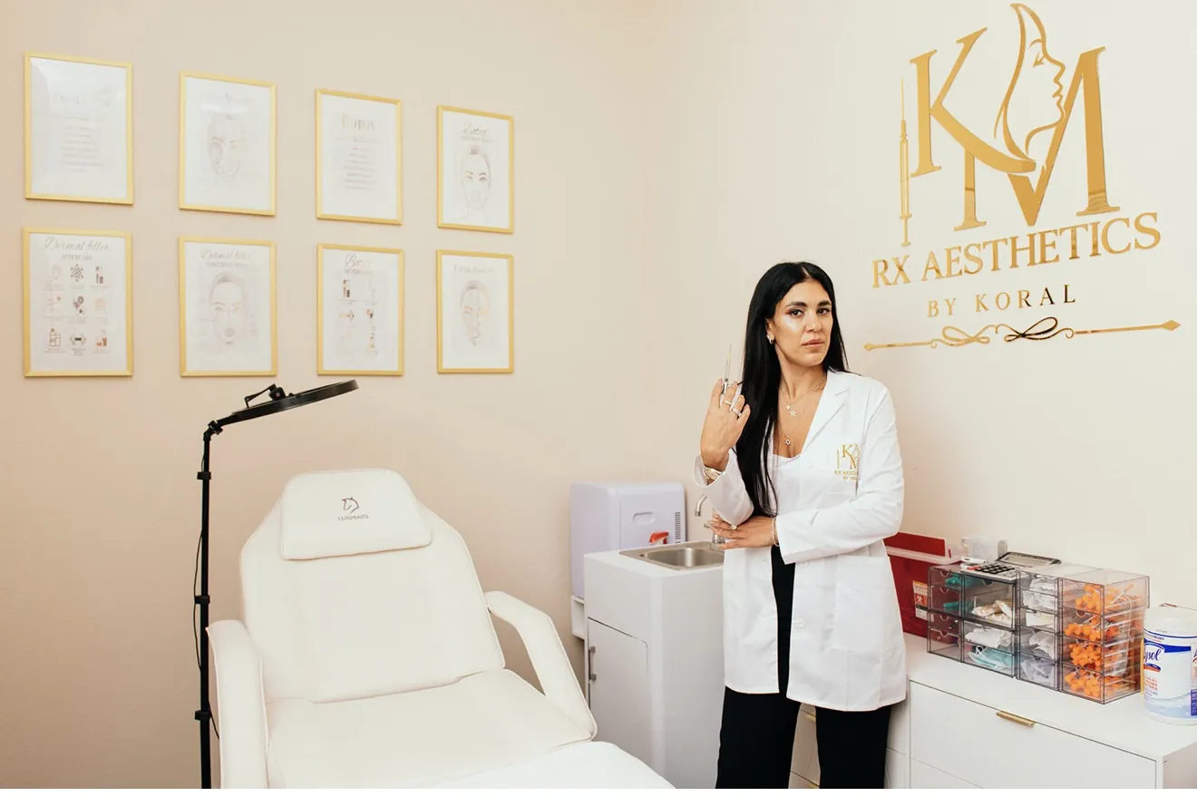 Koral beneath the gold KM RX Aesthetics sign inside the Bellaire studio